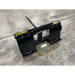 black skid steer attachment with pointed spike on top and yellow "STINGRAY" branding on concrete floor