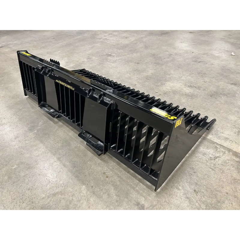 Black steel skid steer rock bucket attachment with spaced tines and reinforced side panels on concrete floor