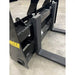 Close-up of black painted steel pallet forks attachment showing mounting frame and fork arms on concrete floor
