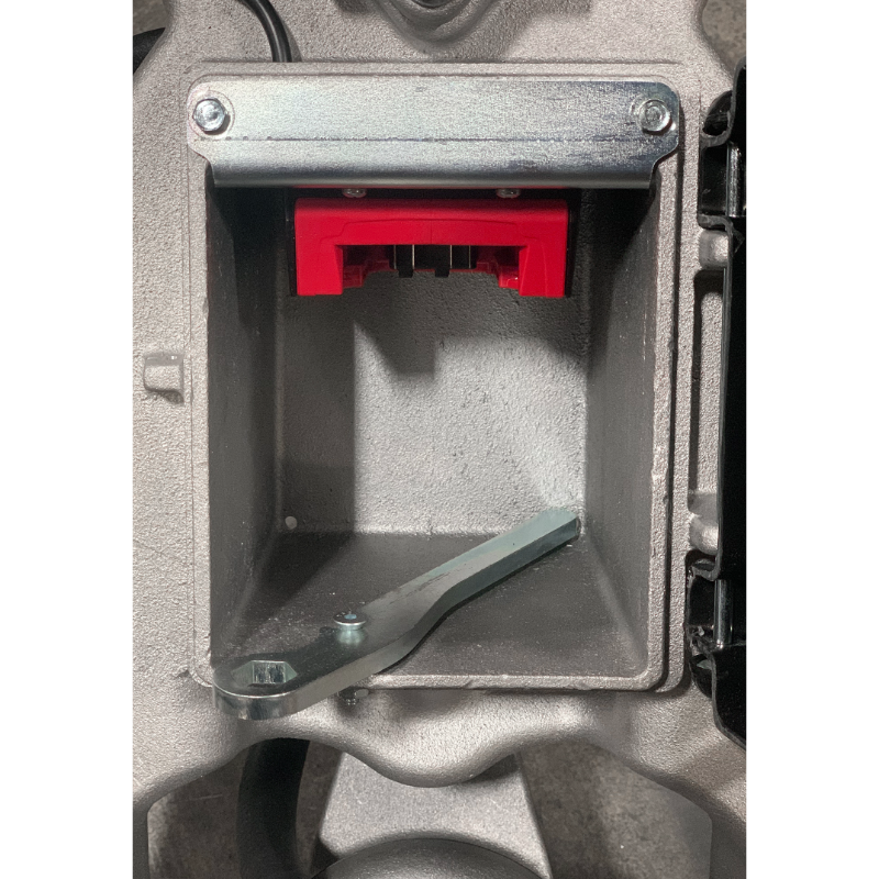 Close-up of MBW 500M ScreeDemon 18V battery-powered vibratory wet screed battery compartment with red release latch, gallery position 1