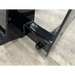 Close-up of black metal equipment frame with bolt fastened on concrete floor background
