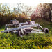 Low-angle view of Swisher 60-inch finish cut mower with 15.5HP engine in grassy field, gallery position 1