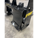Black painted steel skid steer attachment plate with reinforced welds and yellow Stinger Attachments logo on concrete floor