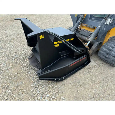 Black steel disc mulcher attachment with hydraulic lines mounted to skid steer on gravel surface
