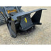 Black metal disc mower attachment with yellow logo mounted on skid steer loader on gravel surface