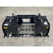 Black steel tractor grapple attachment with hydraulic cylinders, solid tines, and grid-style center on concrete floor