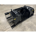 Black steel skid steer rock grapple attachment with dual hydraulic cylinders and spaced curved tines on concrete floor
