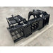 Black steel tractor grapple attachment with hydraulic cylinders, spaced tines, and solid side panels on concrete floor