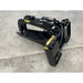 Black steel skid steer stump bucket grapple with hydraulic cylinder and curved grapple arms on concrete floor