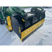 Black and yellow steel snow pusher attachment mounted on green skid steer loader arm on snow-covered ground