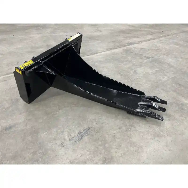 Black metal skid steer stump bucket attachment with tapered scooped body and three pointed digging teeth on concrete floor indoors
