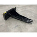 Black steel skid steer stump bucket attachment with three digging teeth on warehouse concrete floor indoors