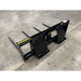 Black steel skid steer bale spear attachment with four tines and reinforced frame on concrete floor viewed from back left angle