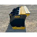 Right side view of black and yellow skid steer snow pusher attachment with bolted cutting edge on gravel surface