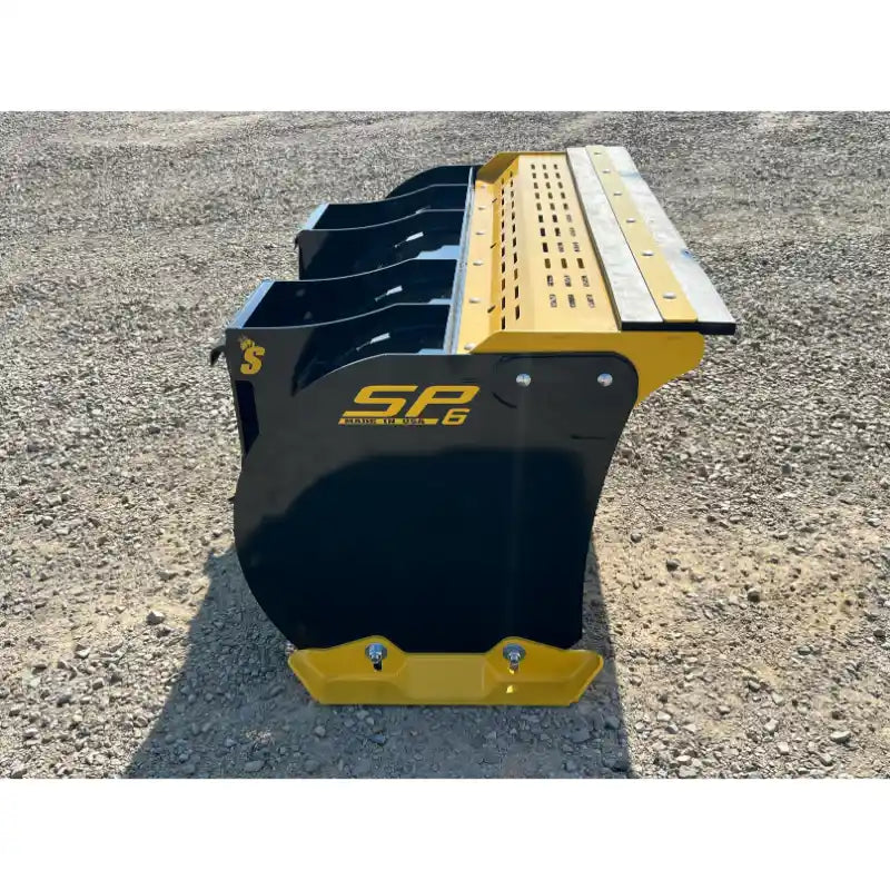 Right side view of black and yellow skid steer snow pusher attachment with bolted cutting edge on gravel surface