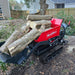 Red MechMaxx D50HTFL tracked dumper loaded with large tree logs in bucket, gallery position 1