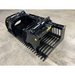 Black painted steel skid steer rock grapple attachment with twin hydraulic cylinders and spaced curved tines on concrete floor