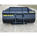 Front view of black steel construction material bucket attachment with yellow model markings on gravel surface