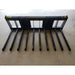 Black metal manure tine attachment with ten spaced tubular tines and solid rectangular frame on concrete floor indoors