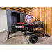 Operator loading large log onto Swisher 22-Ton Timber Brute Eco Split electric log splitter, gallery position 1