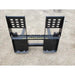 Black steel pallet fork attachment with backrest and mounting brackets on gravel surface